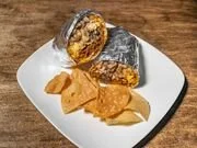 A plate with a piece of grilled fish, fried plantains, and a serving of rice.