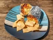 A plate with assorted baked goods including cookies, cake slices, and possibly bars, on a blue and white plate.
