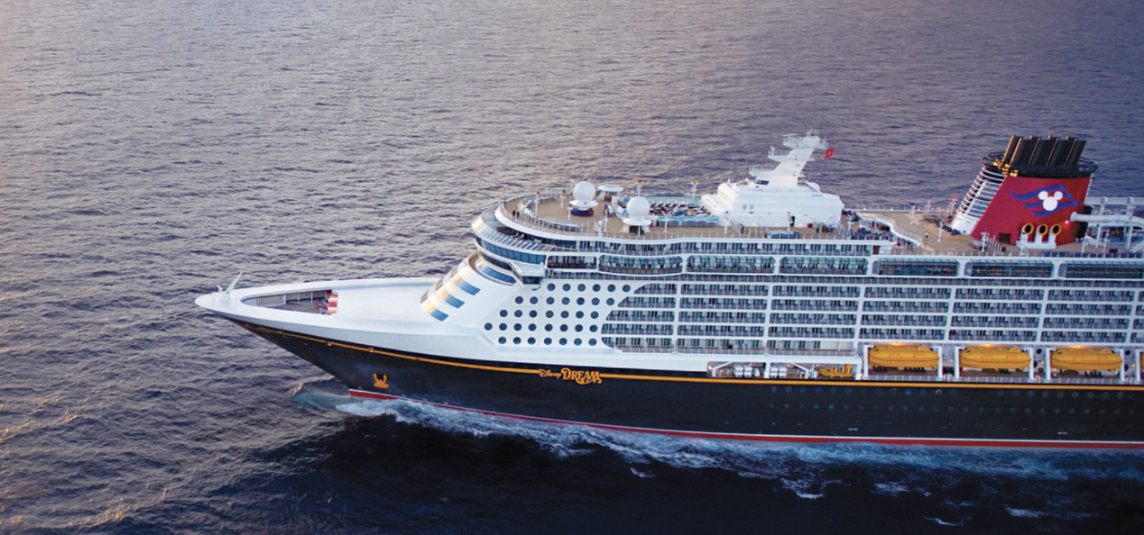A large cruise ship sailing on open water during sunset.