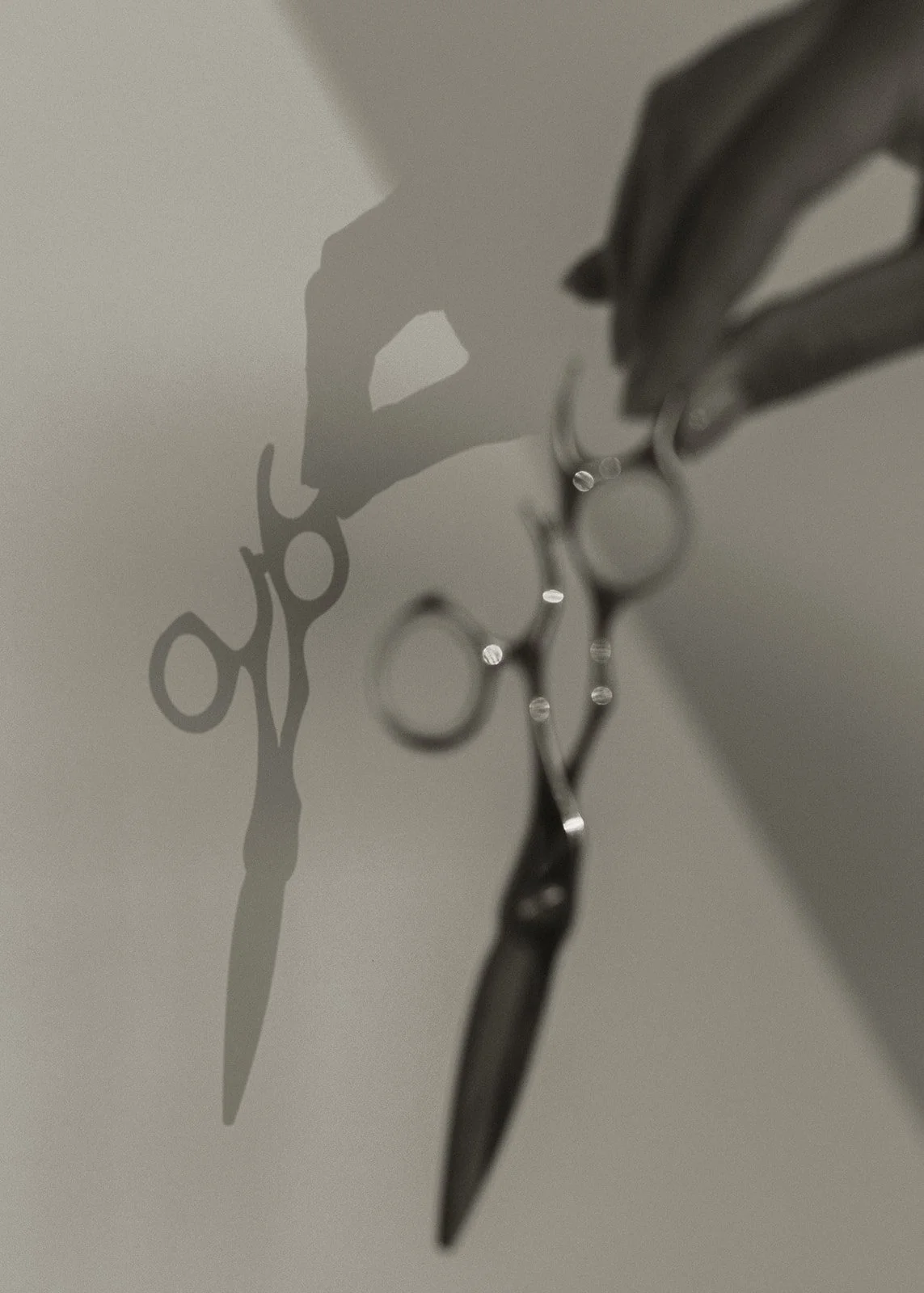 A pair of surgical scissors reflecting on the ceiling, casting a shadow on the wall.