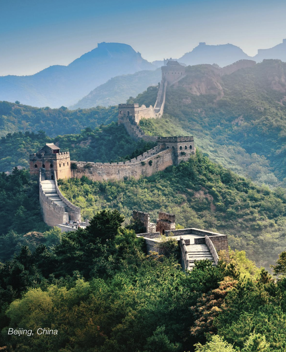 The Great Wall of China winding through greenmountainous terrain with foggy peaks in the background, labeled 'Beijing, China.'