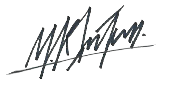 Close-up of a handwritten signature on white paper.