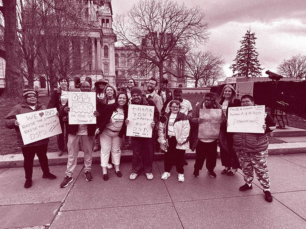 group of people with signs in Springfield, IL advocating for increased I/DD DSP wages