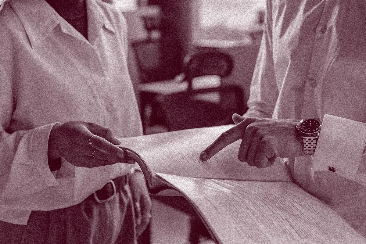 members of nonprofit shared back office services team looking at paperwork and data together
