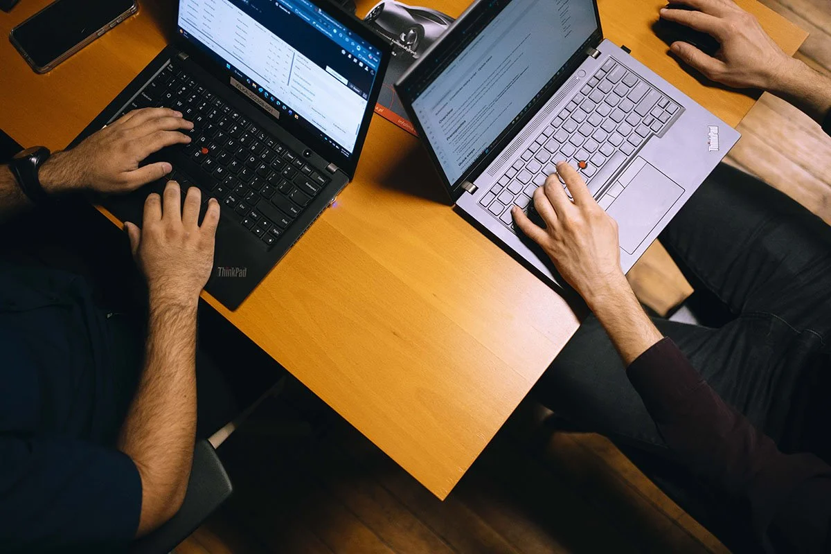 close shot of Keystone Alliance's shared IT services team typing on laptops