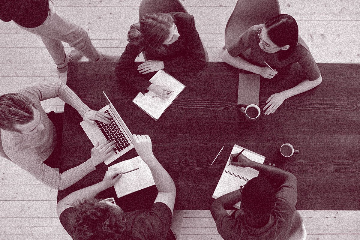 overhead shot of nonprofit shared back office services team collaborating around a table
