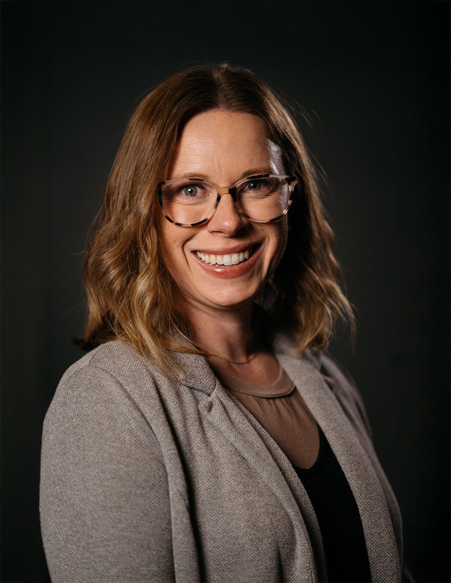 professional headshot of Cory Gumm on dark background