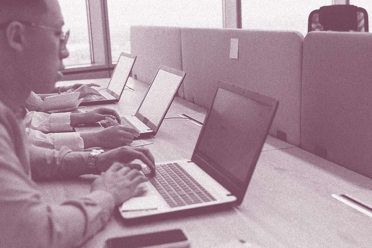 nonprofit IT team working on computers to overcome nonprofit IT roadblocks