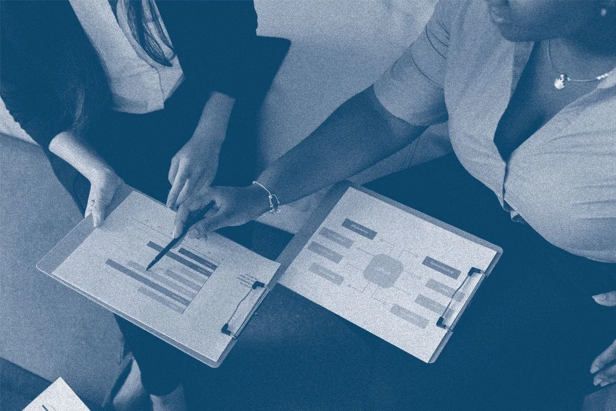 nonprofit shared financial services team looking at report together