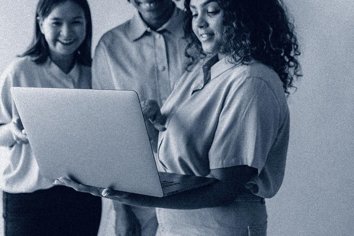 nonprofit team members with computer discussing tech adoption, data, and cybersecurity