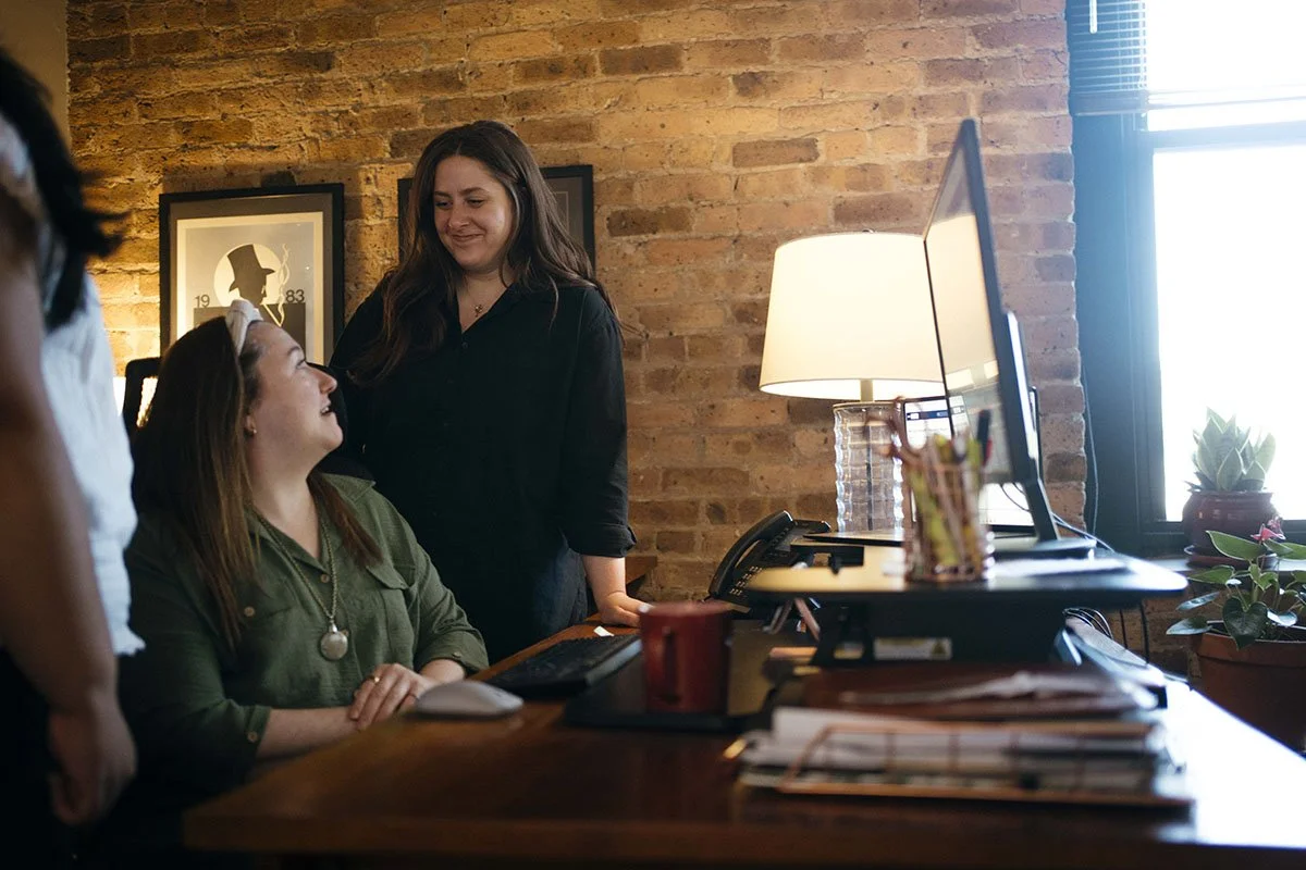 Keystone Alliance team members talking and working together at desk