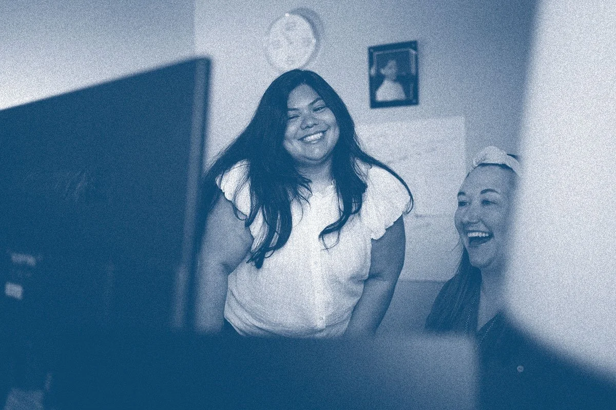 Keystone Shared Services team members smiling and looking at computer together