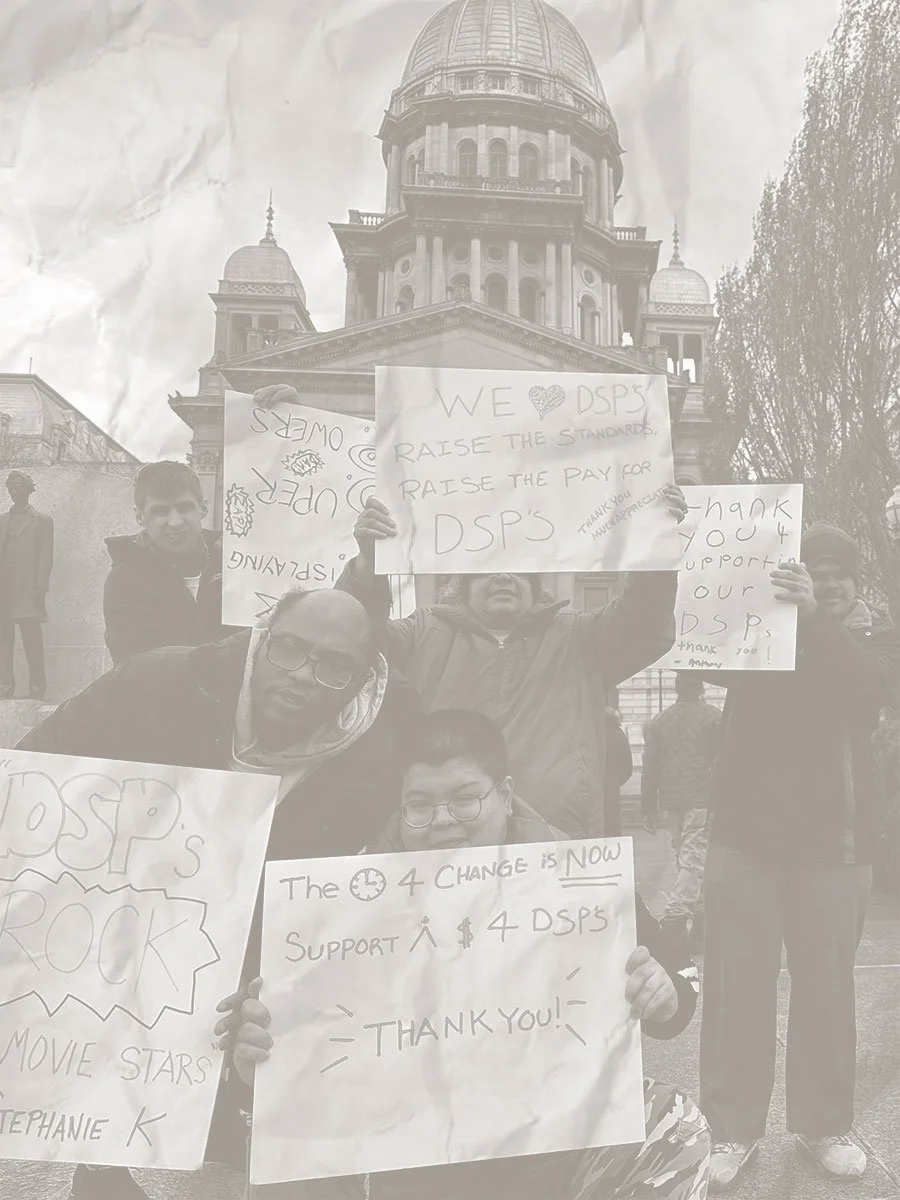 people with support signs for Illinois IDD nonprofit advocacy efforts