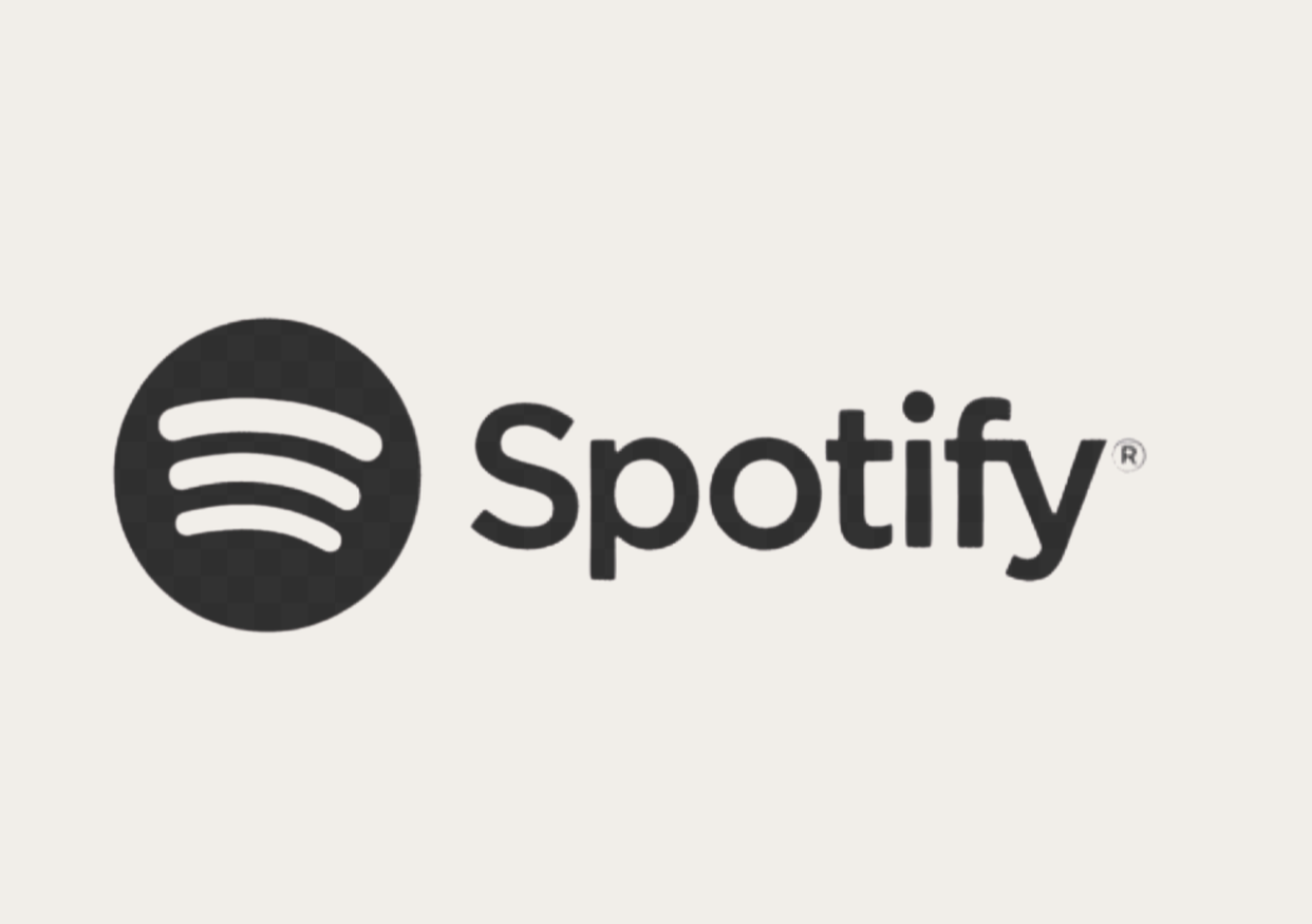 Spotify logo with black circular icon with three curved lines and the word 'Spotify' in black text on a light background.