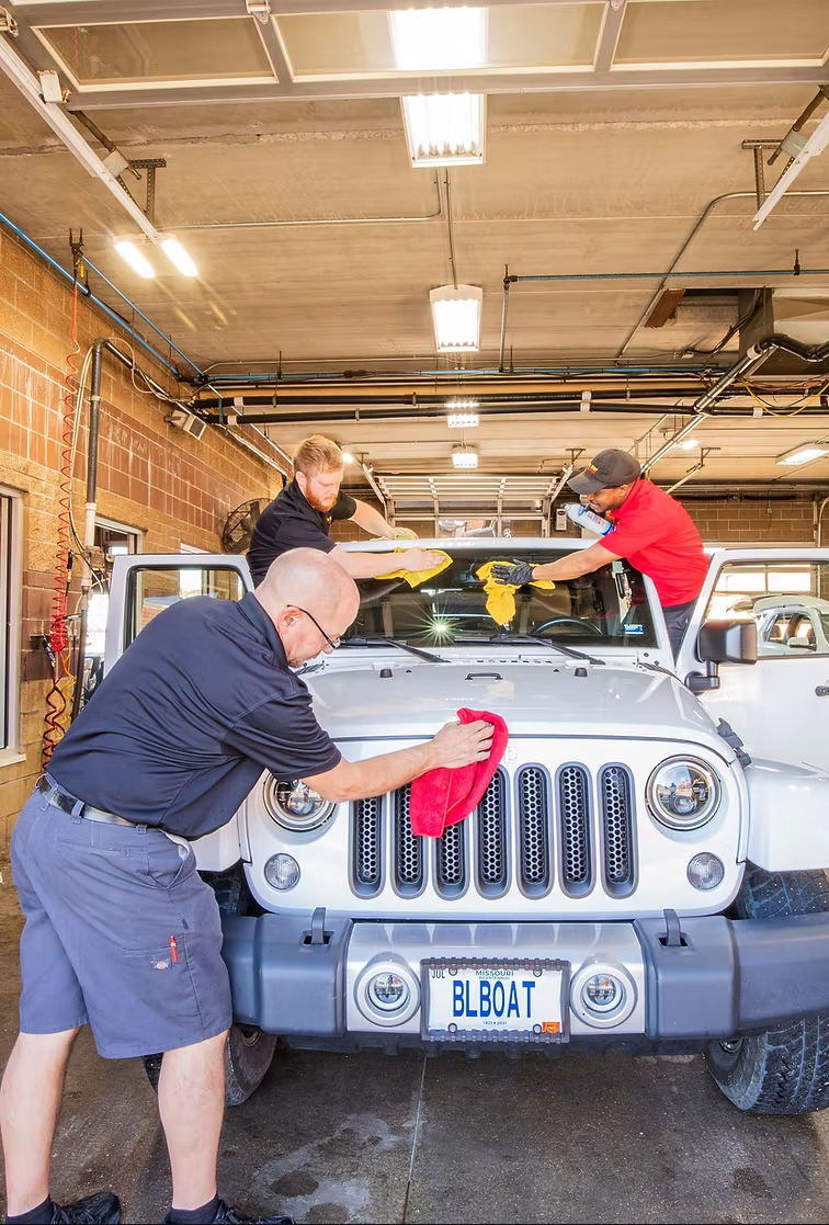 A shiny vehicle receiving a premium Armor All Ceramic Protective Coating at The Wash Shop express car wash.