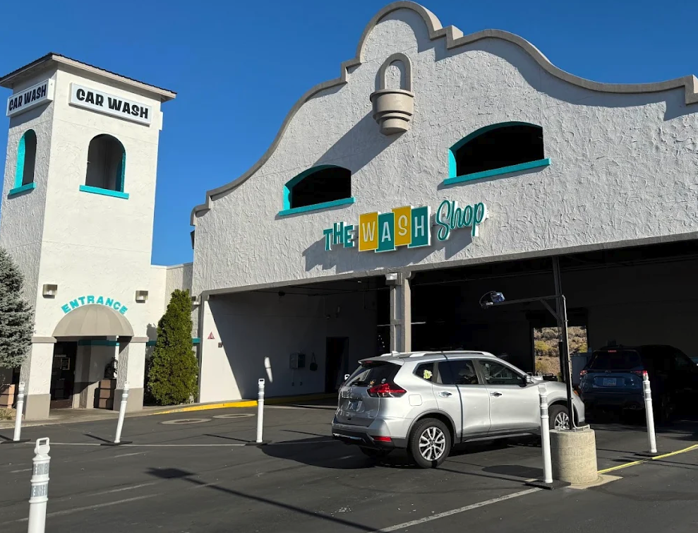 silver SUV queuing at the automated entrance of The Wash Shop express car wash location.