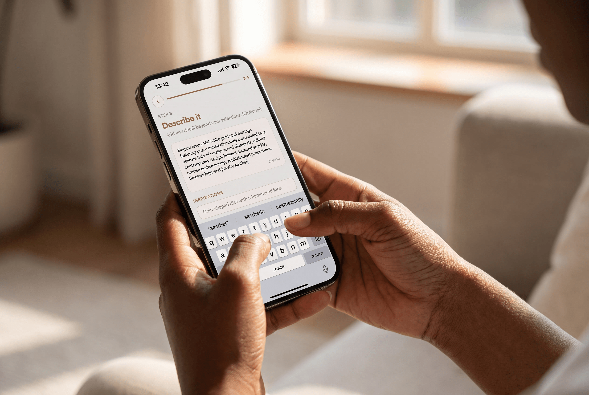 Hands typing a luxury diamond stud earring description into a jewelry design app