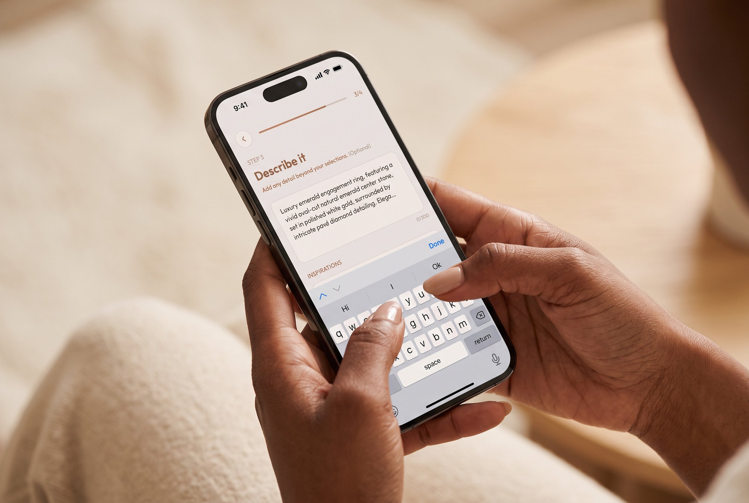 Hands typing a ring description into a jewelry design app's Describe It step on a smartphone