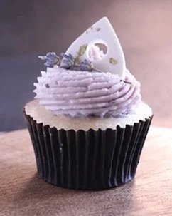 Spirit Board: Delicate vanilla and lavender cake with blackberry buttercream, topped with a white callebaut chocolate Ouija planchette.