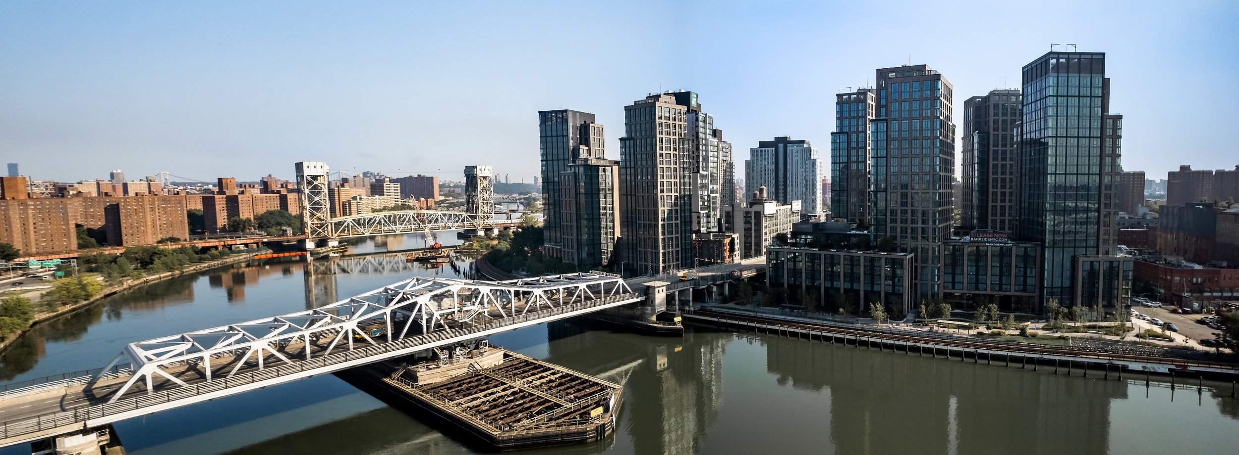 3rd Avenue Bridge over the Harlem River with high-rise buildings, Lincoln at Bankside, and residential buildings are visible in the background.