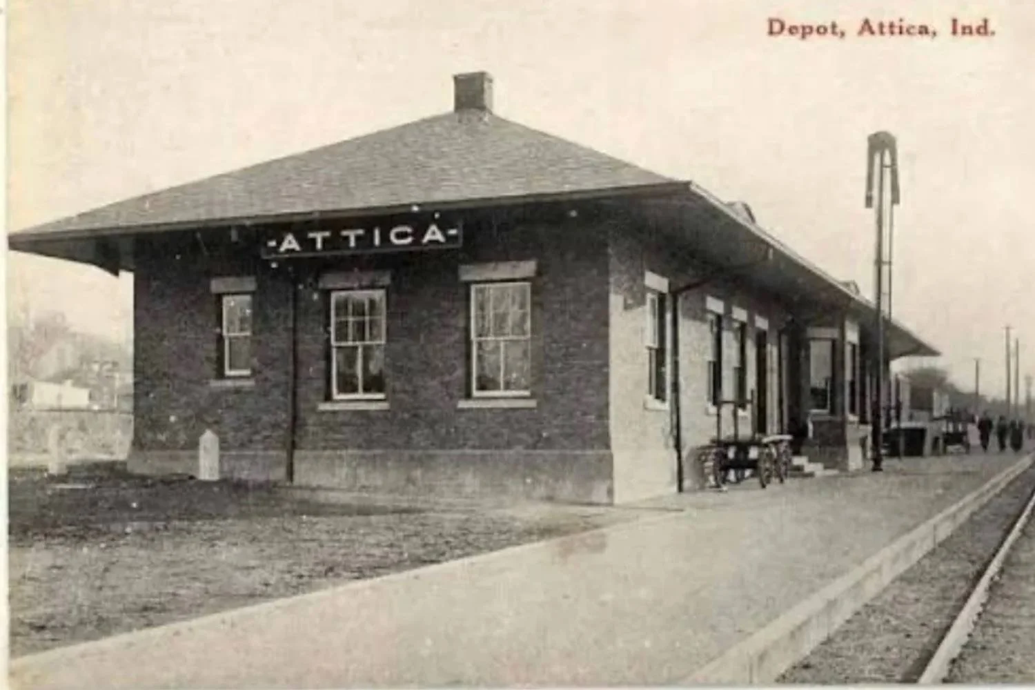 Historic black-and-white photo of the Attica train depot building.
