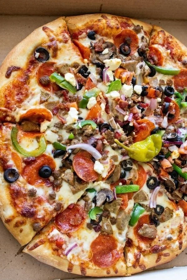 Specialty pizza topped with pepperoni, olives, peppers, onions, mushrooms, and banana pepper.