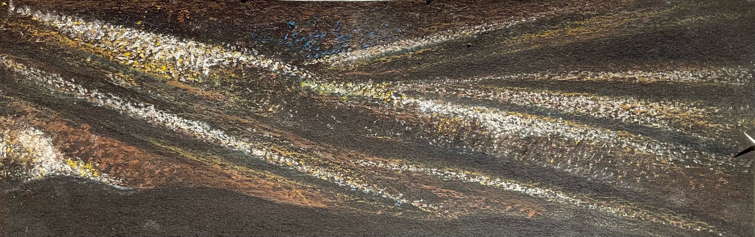 Close-up of a textured metallic surface with rust, yellow, and white patches.