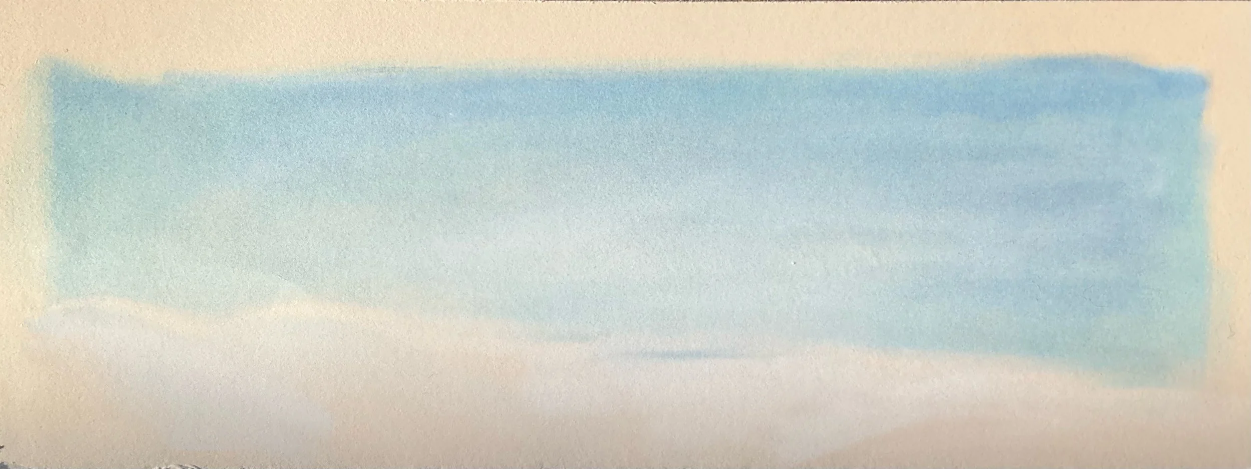 A horizontal watercolor painting with shades of blue blending into beige.