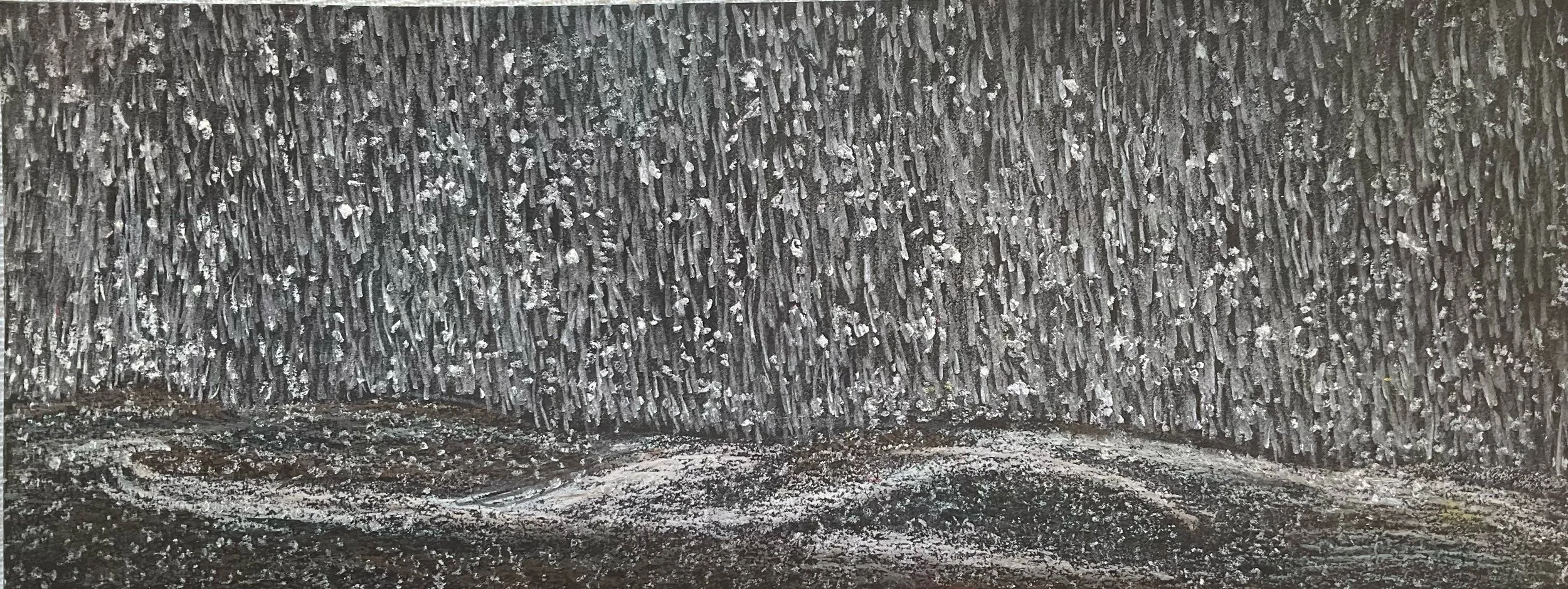 Close-up of a textured, vertical gray surface with small, uneven protrusions.