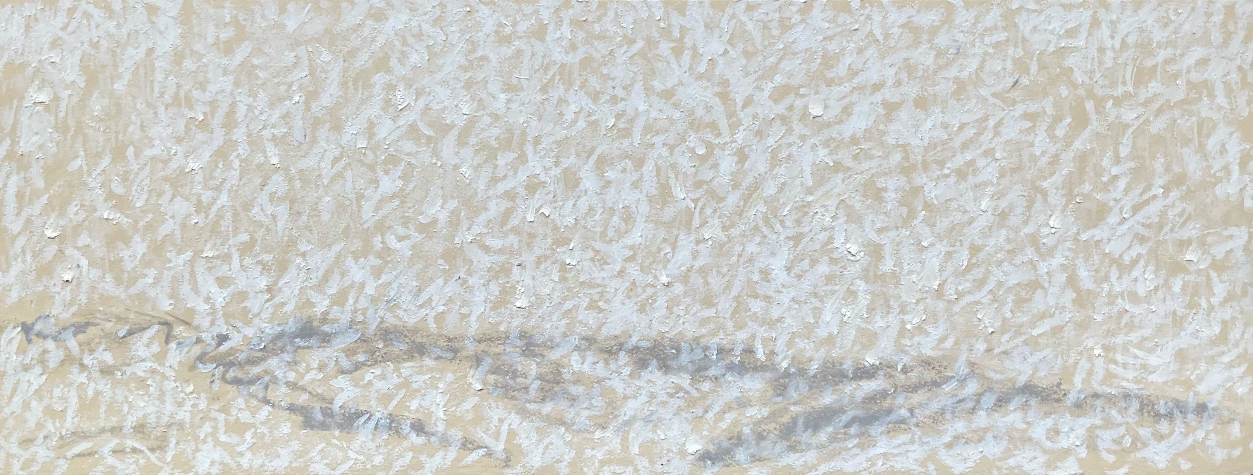 Close-up of a textured beige wall with a faint trace of grayish smudges or markings near the bottom of the image.