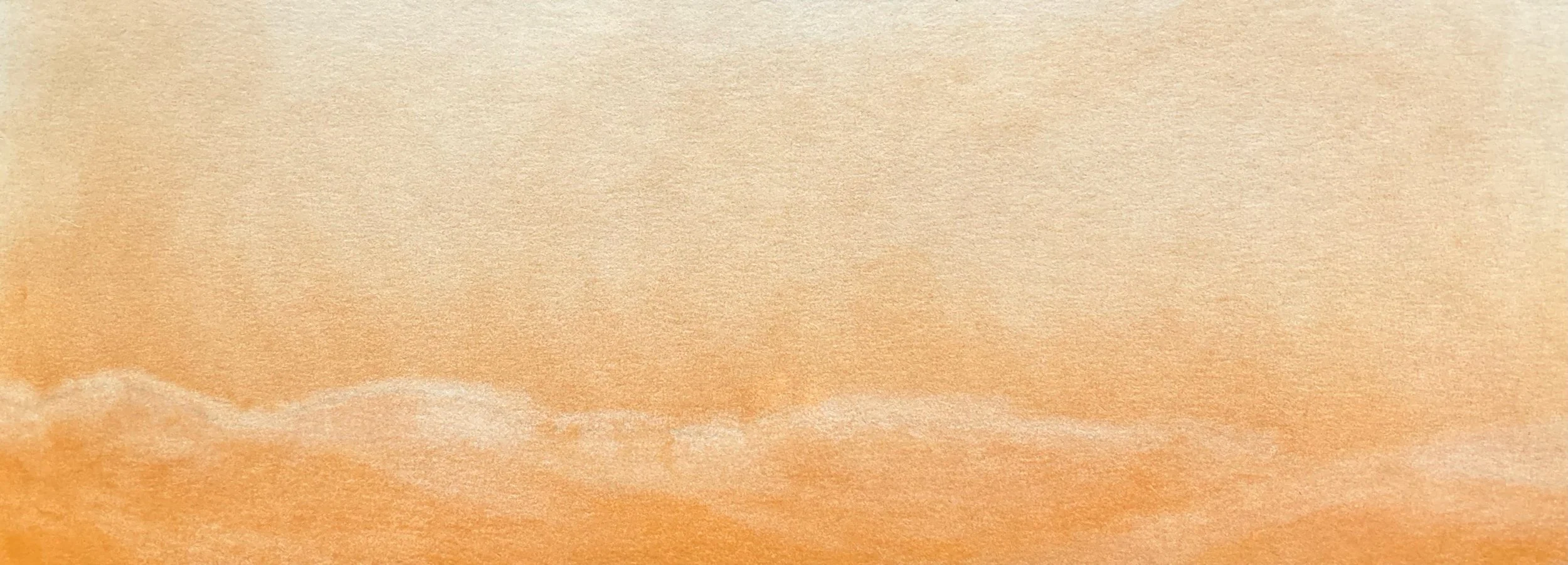 A close-up view of colorful pastel paper with shades of orange, peach, and beige.