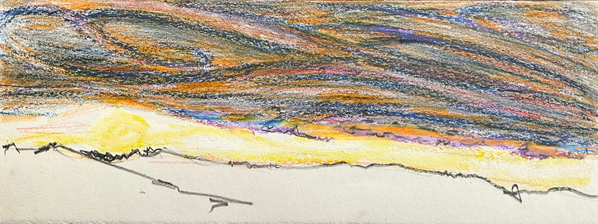 A colorful sunset or sunrise with a vast sky filled with streaks of orange, yellow, purple, and dark blue, over a silhouette of a hilly landscape.