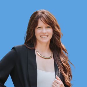 A woman with long brown hair, wearing a black blazer and a white top, smiling against a blue background.