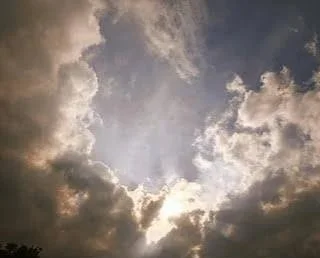 Clouds parting to reveal the sun, representing the Self to emerging in Internal Family Systems (IFS) therapy.