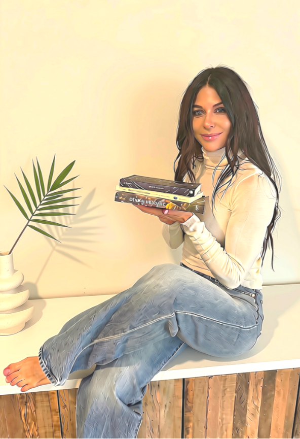 Christy Westra holding recommended books on eating disorders, healing, relationships, and personal growth