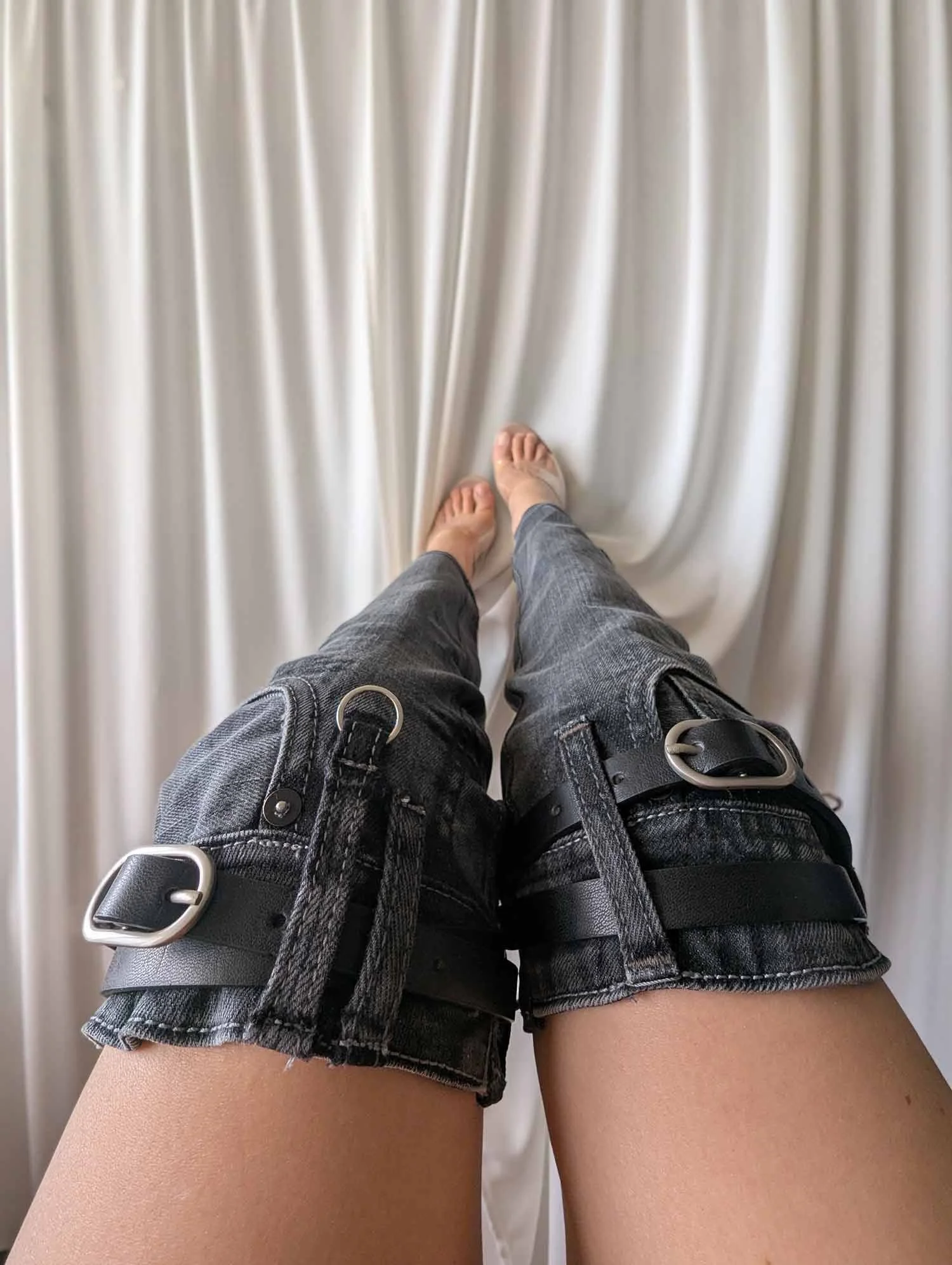 Straight-leg-upcycled-black-denim-leg-warmers-with-leather-belts-and-metallic-hardware-1.jpg