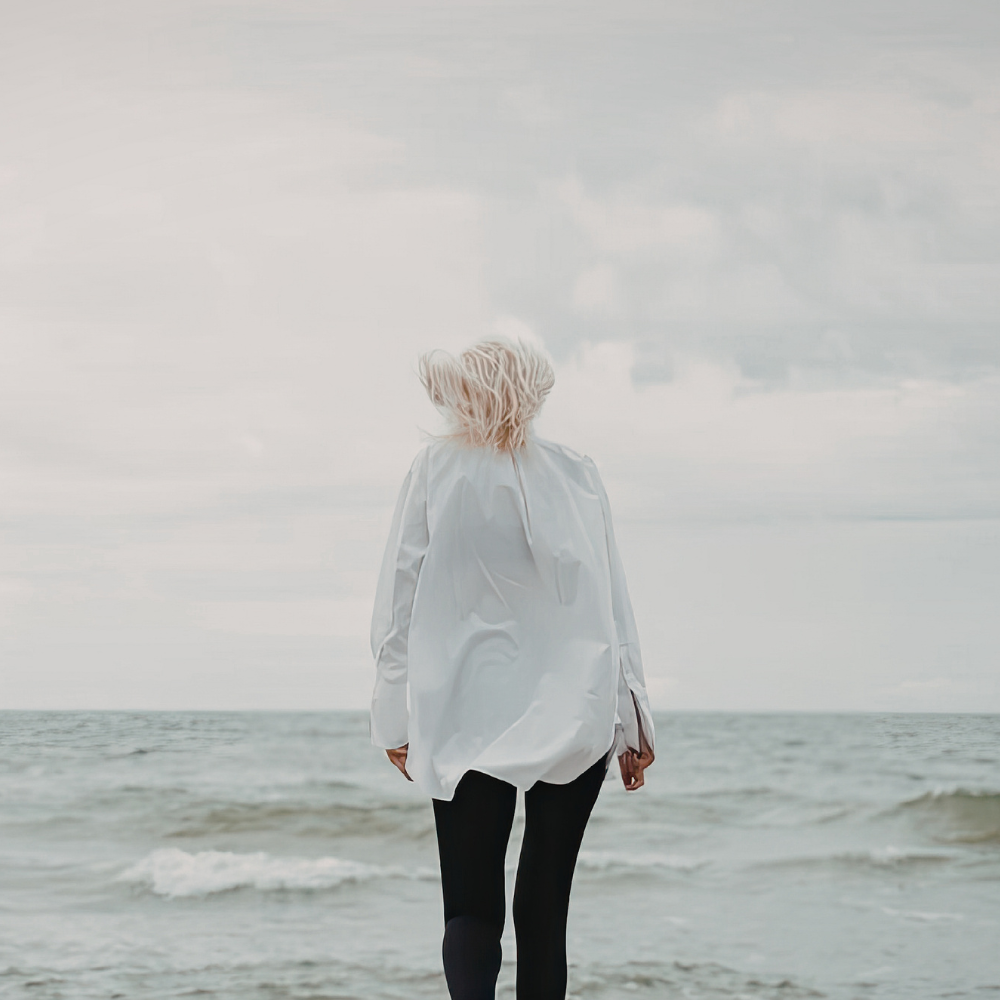 Woman walking toward ocean symbolizing ADHD self-trust, emotional processing, and reconnecting with yourself