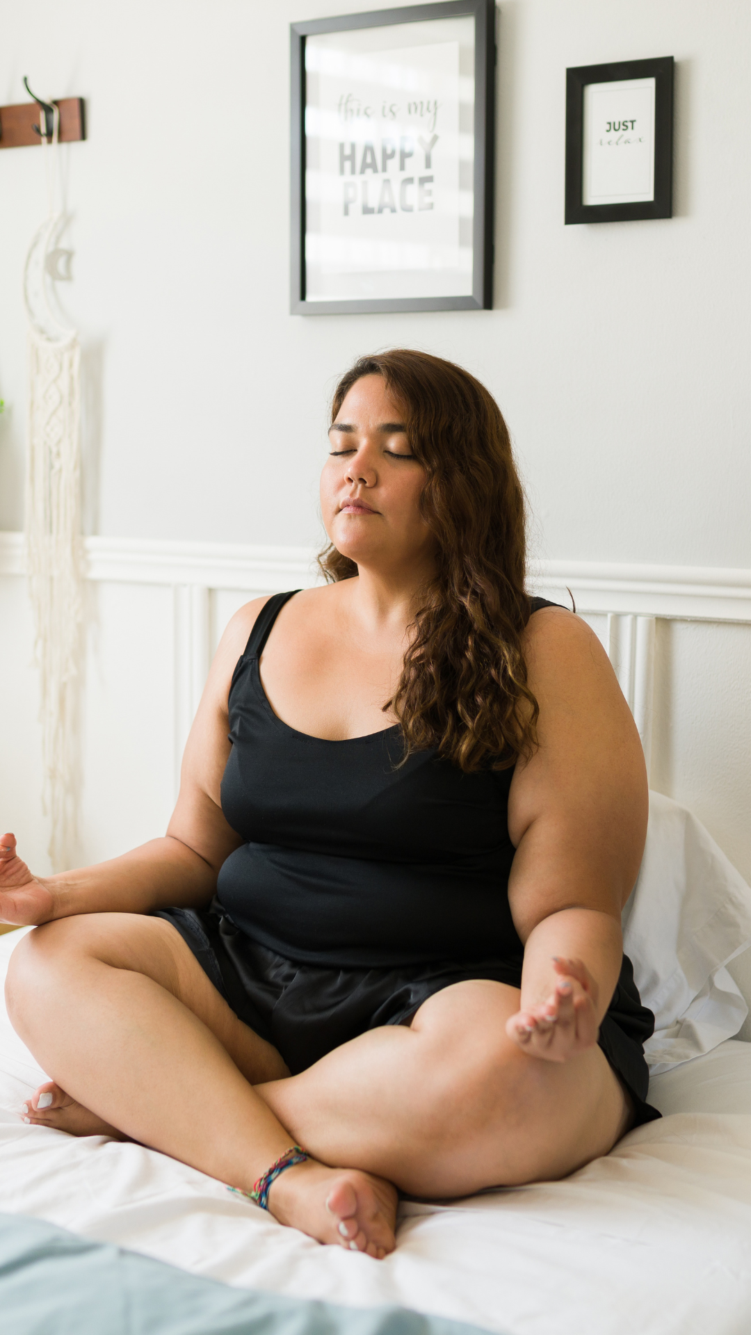 Neurodivergent woman sitting on a bed practicing a simple grounding meditation at home for nervous system regulation