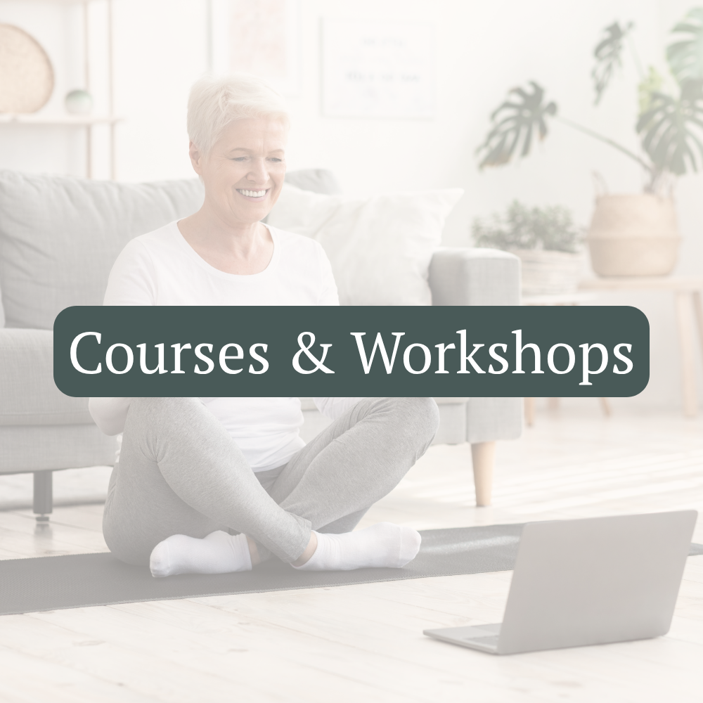 A woman sits comfortably at home while taking an online course on her laptop.