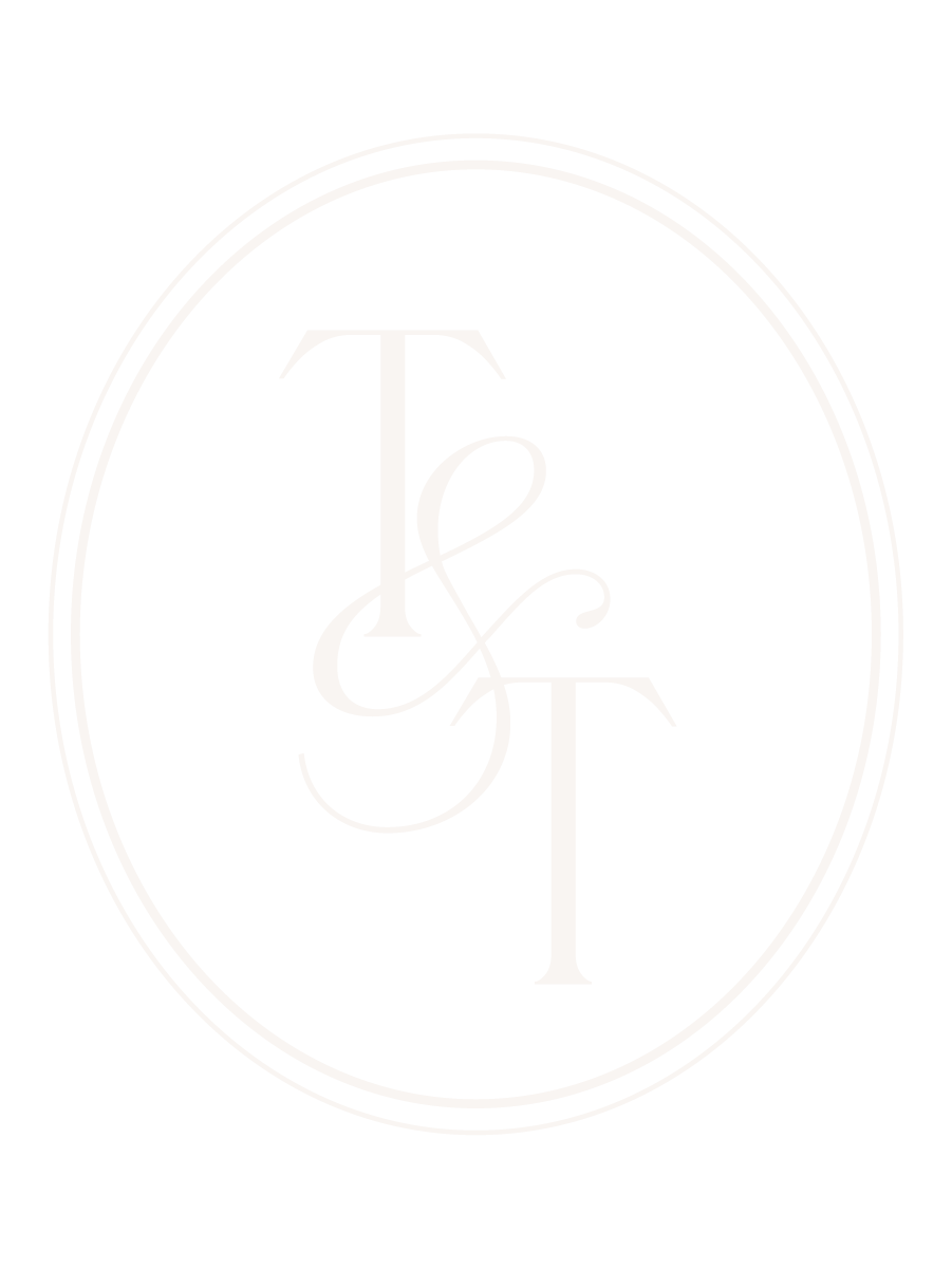 Black background with a white oval border and the intertwined initials T and S in elegant font inside the oval.