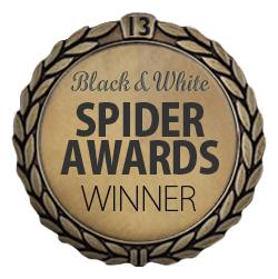 A circular award badge with a black and white laurel wreath design. The center features text: 'Black & White Spider Awards Winner.'