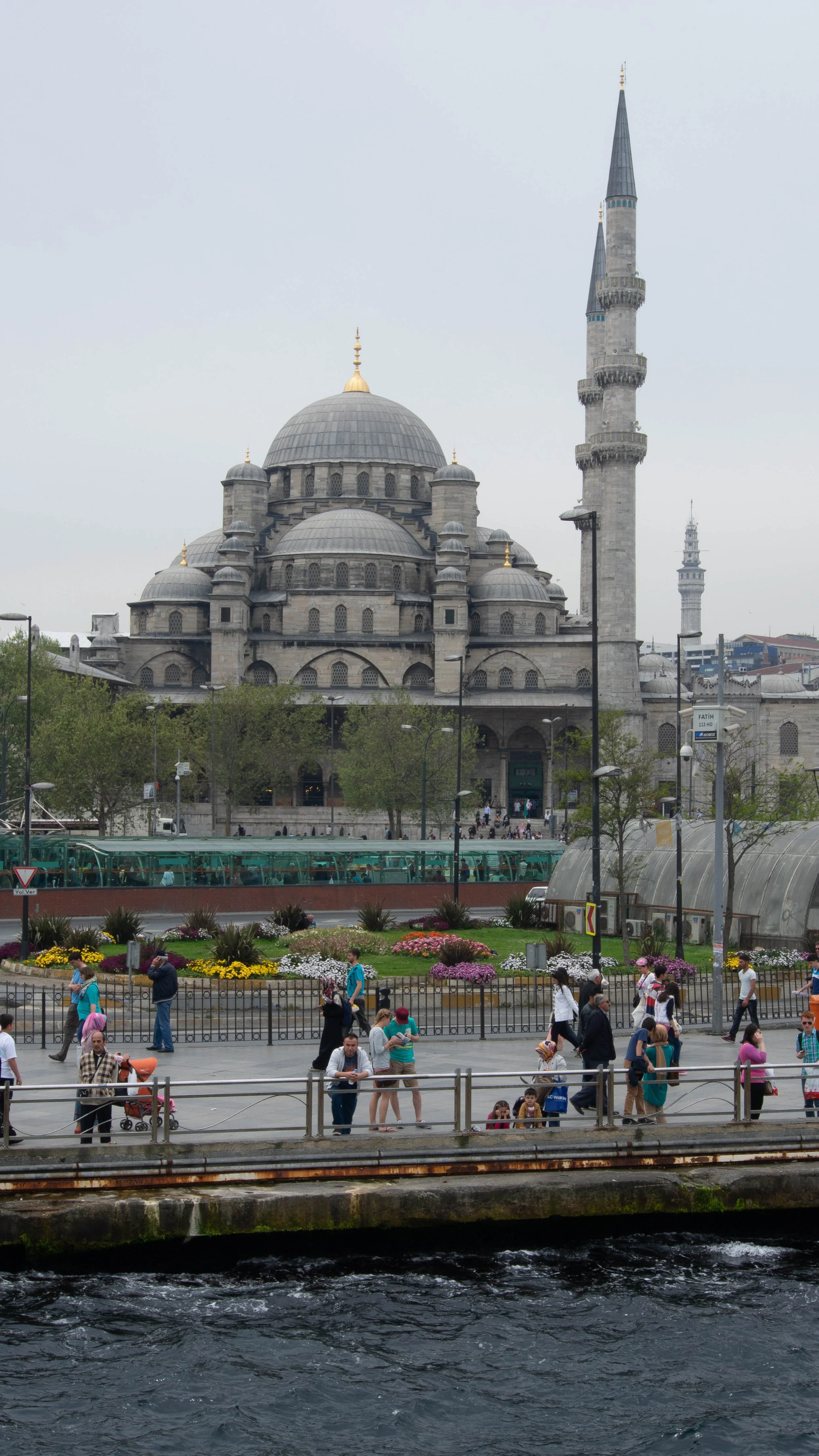 A  mosque done in the Ottoman style located in Istanbul with the Bosporus sea in the foreground 