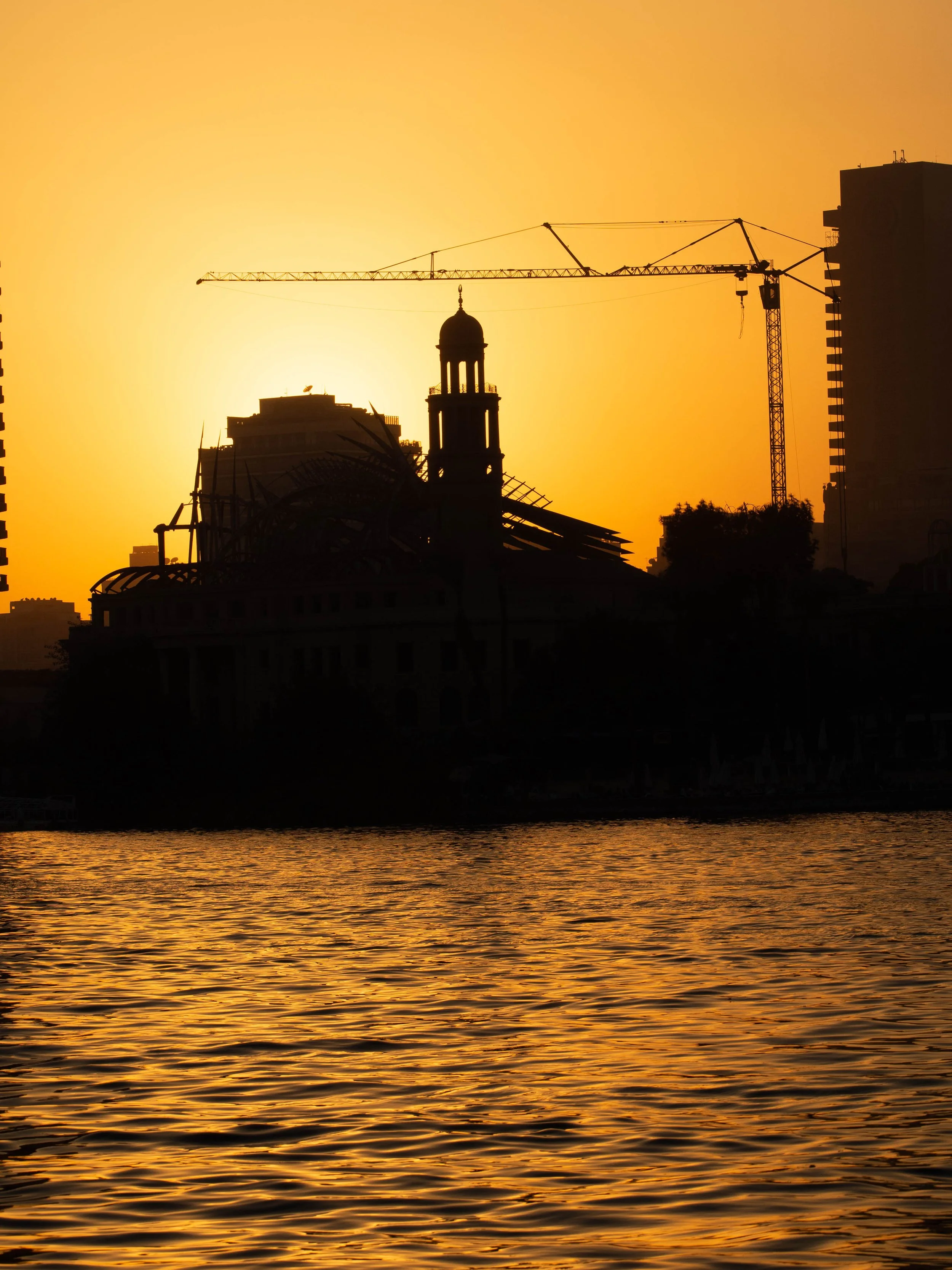 a modern mosque at the side of the river nile