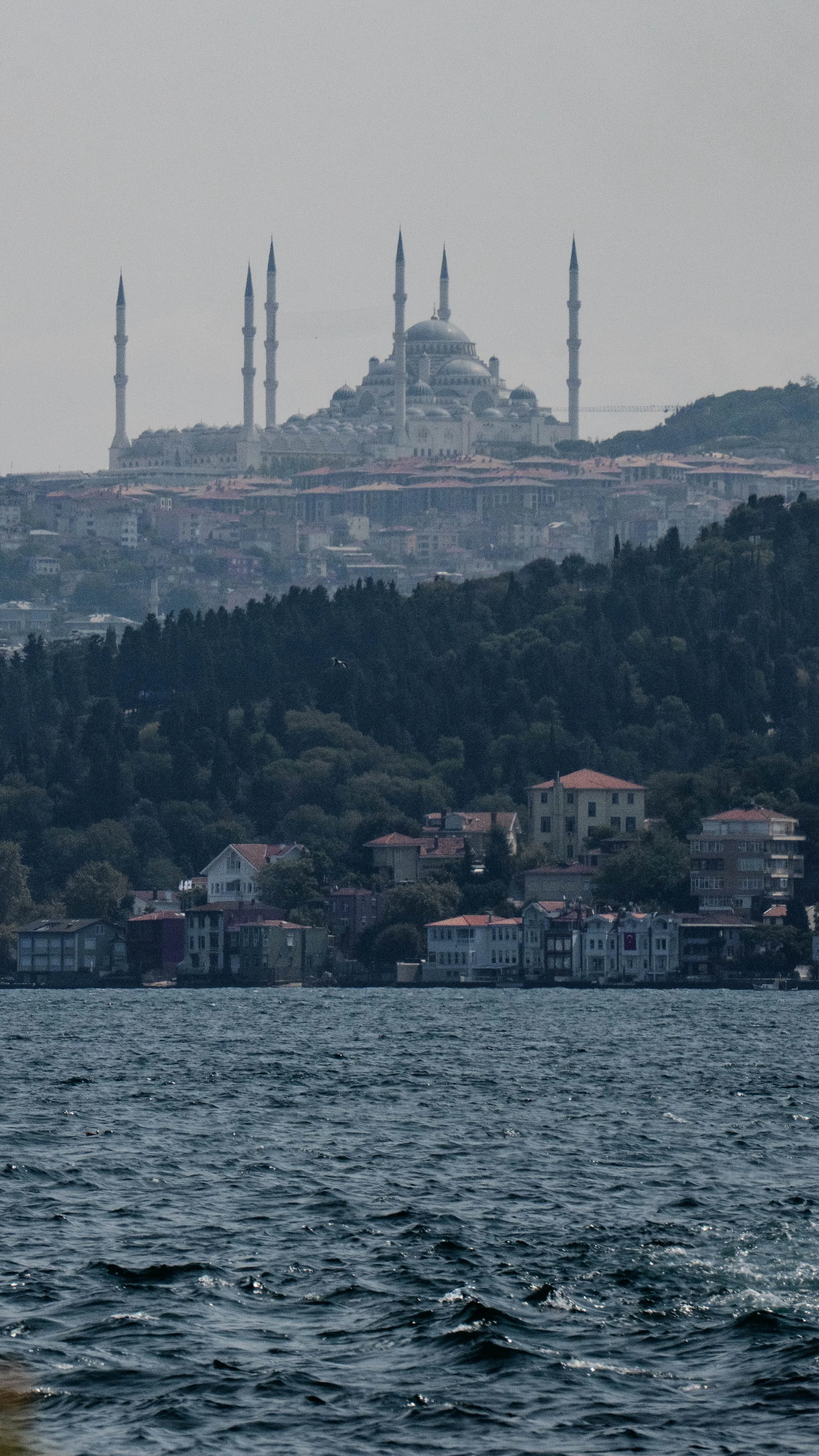 A modern mosque done in the Ottoman style located at the Asian side of Istanbul with the Bosporus sea in the foreground 
