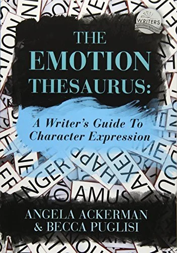 Book cover for 'The Emotion Thesaurus: A Writer's Guide to Character Expression' by Angela Ackerman and Becca Puglisi. The cover features a background of scattered word cards with various words, and the title and authors' names are prominently displayed.