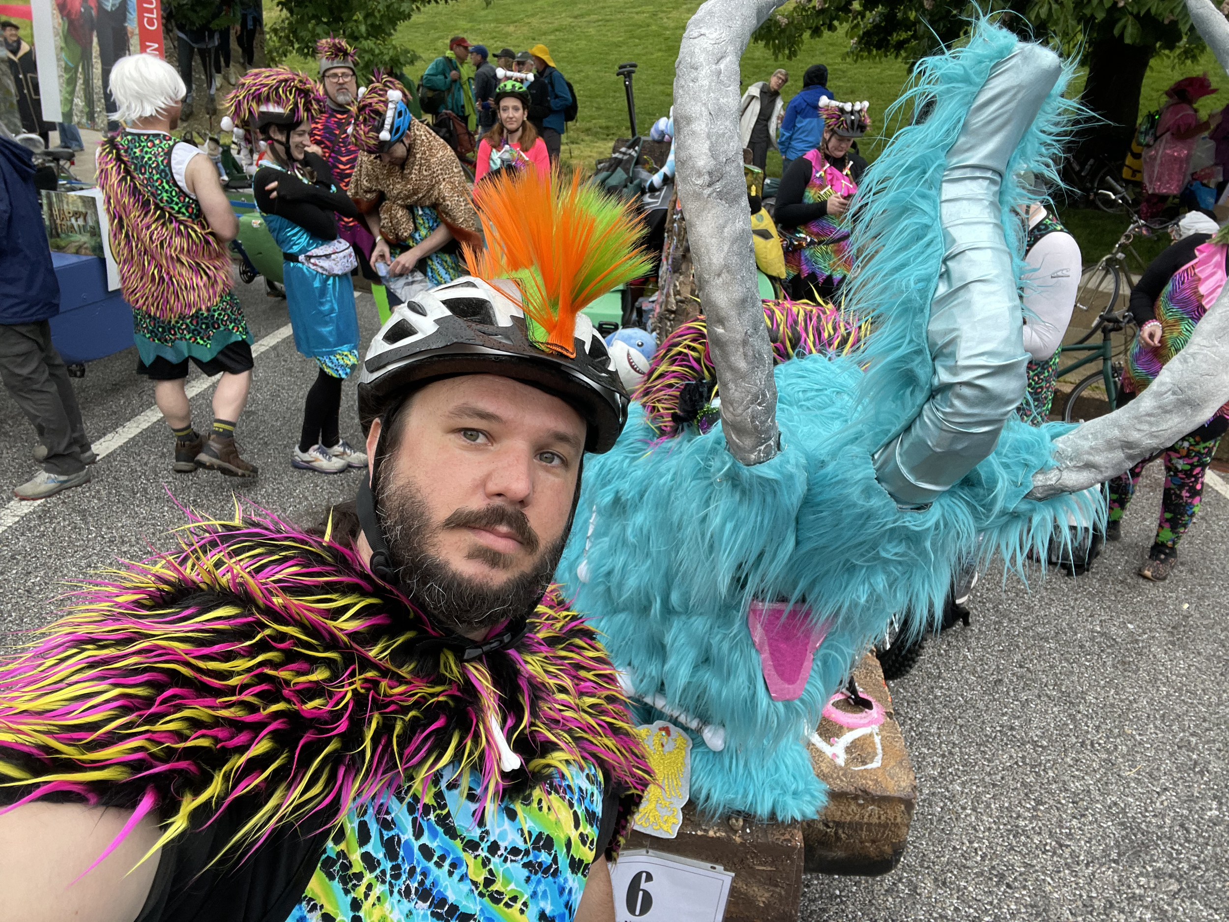 Democratic central committee district 46 candidate Thomas Wingate dressed in neon animal prints posing with a kinetic sculpture