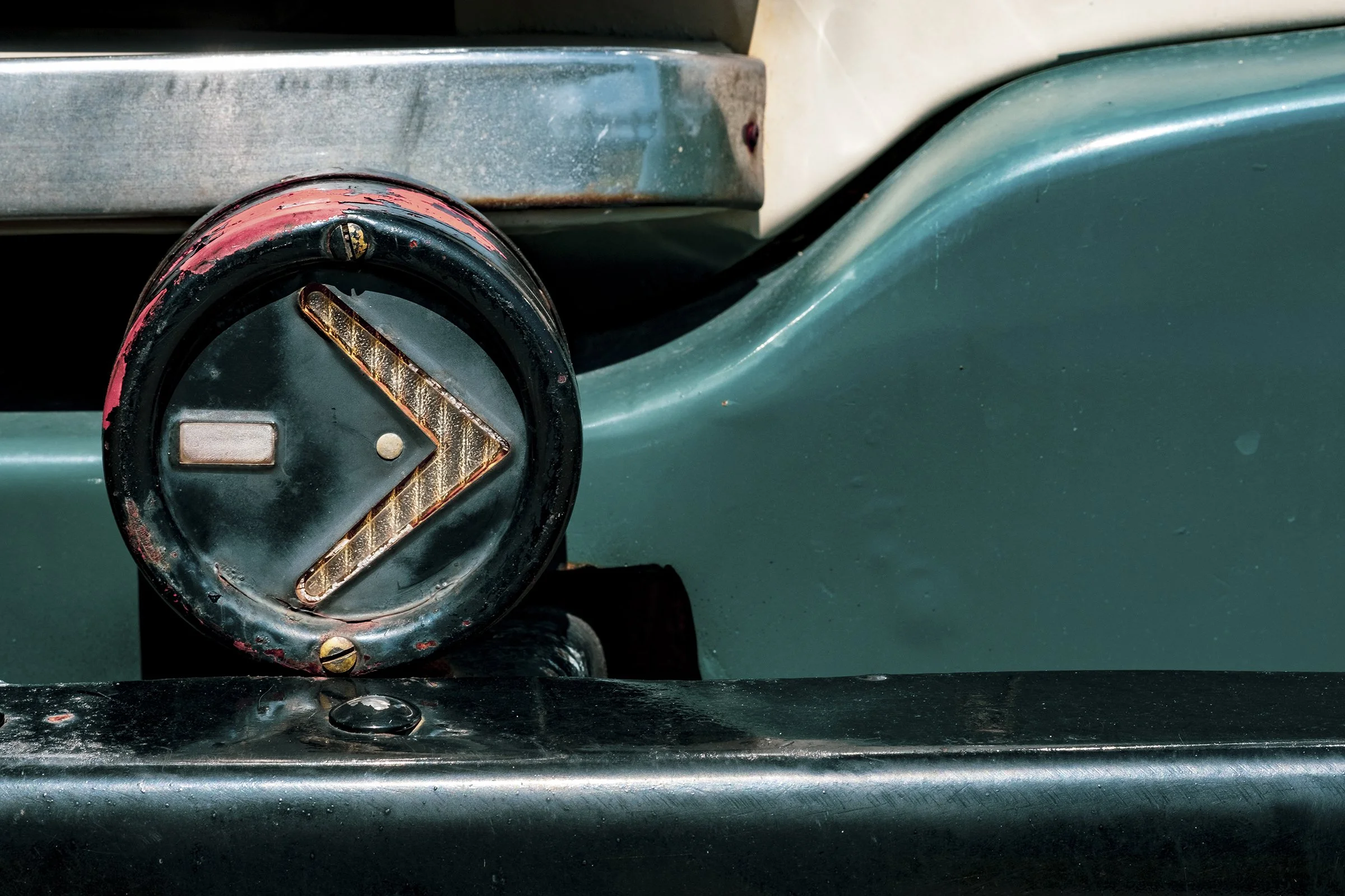 Close-up of a vintage sewing machine's tension knob and surrounding metal parts showing signs of rust and wear.