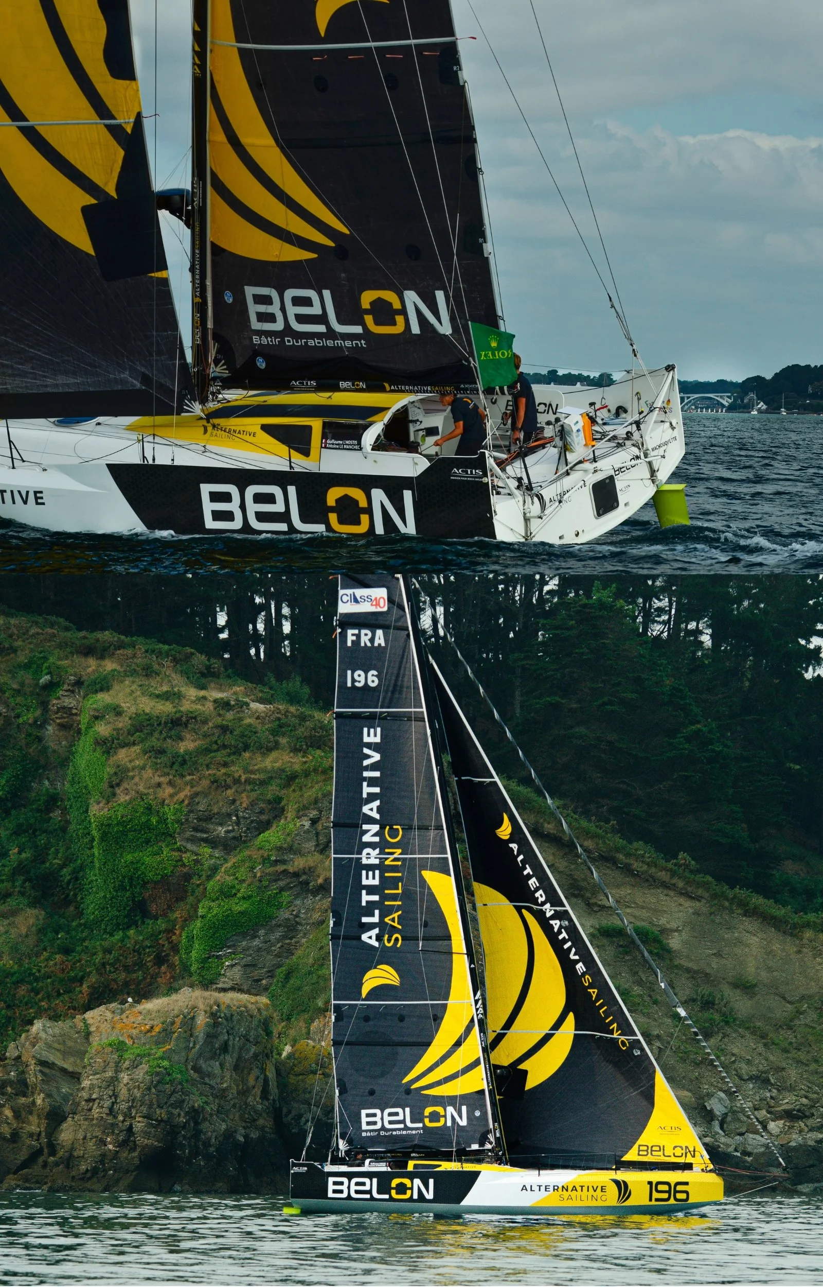 Un voilier de course avec des voiles noirs et jaunes portant le nom BELON navigue sur l'eau, avec un paysage rocheux et verdoyant en arrière-plan.