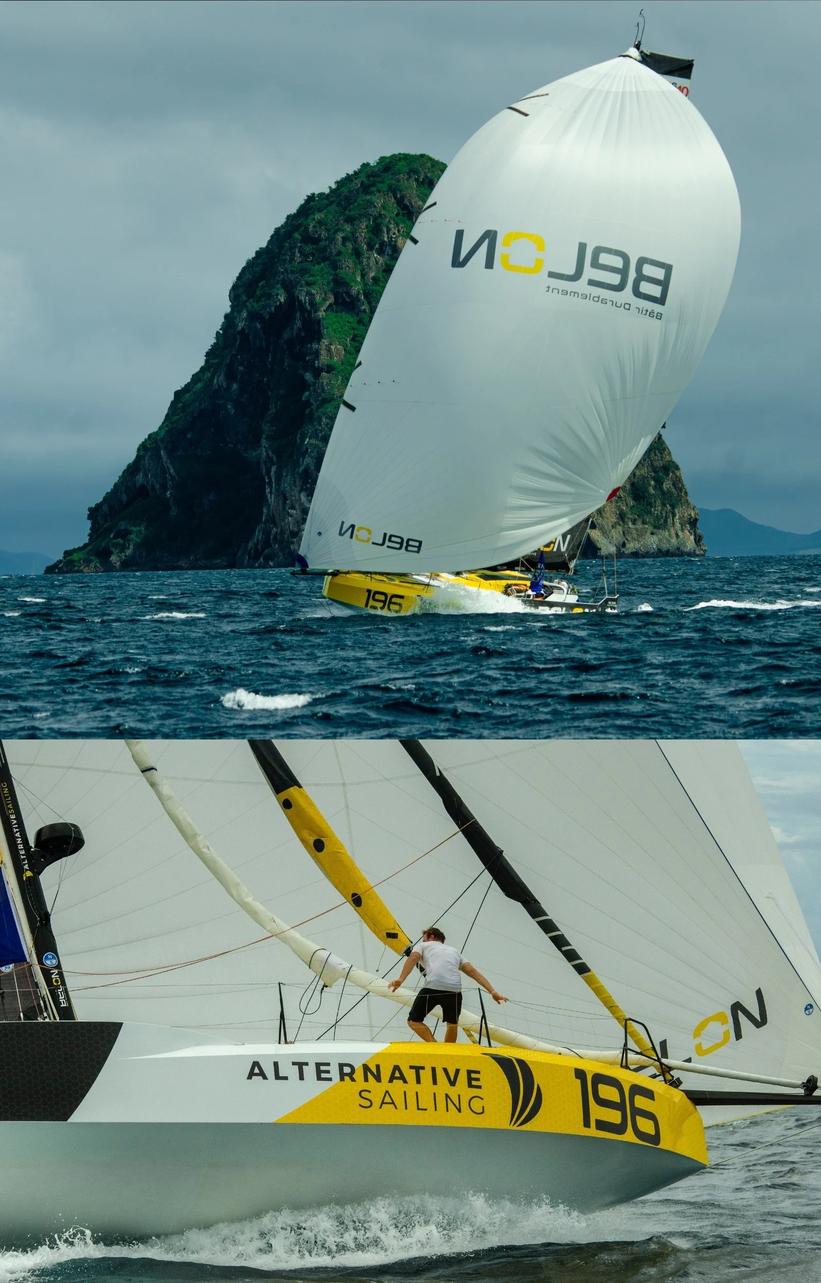 Un voilier de compétition orange avec la marque 'ALTERNATIVE SAILING' sur la coque navigue à grande vitesse sur l'eau, avec une grande voile blanche portant le logo 'BELON'. En arrière-plan, une île rocheuse recouverte de végétation s'élève au-dessus