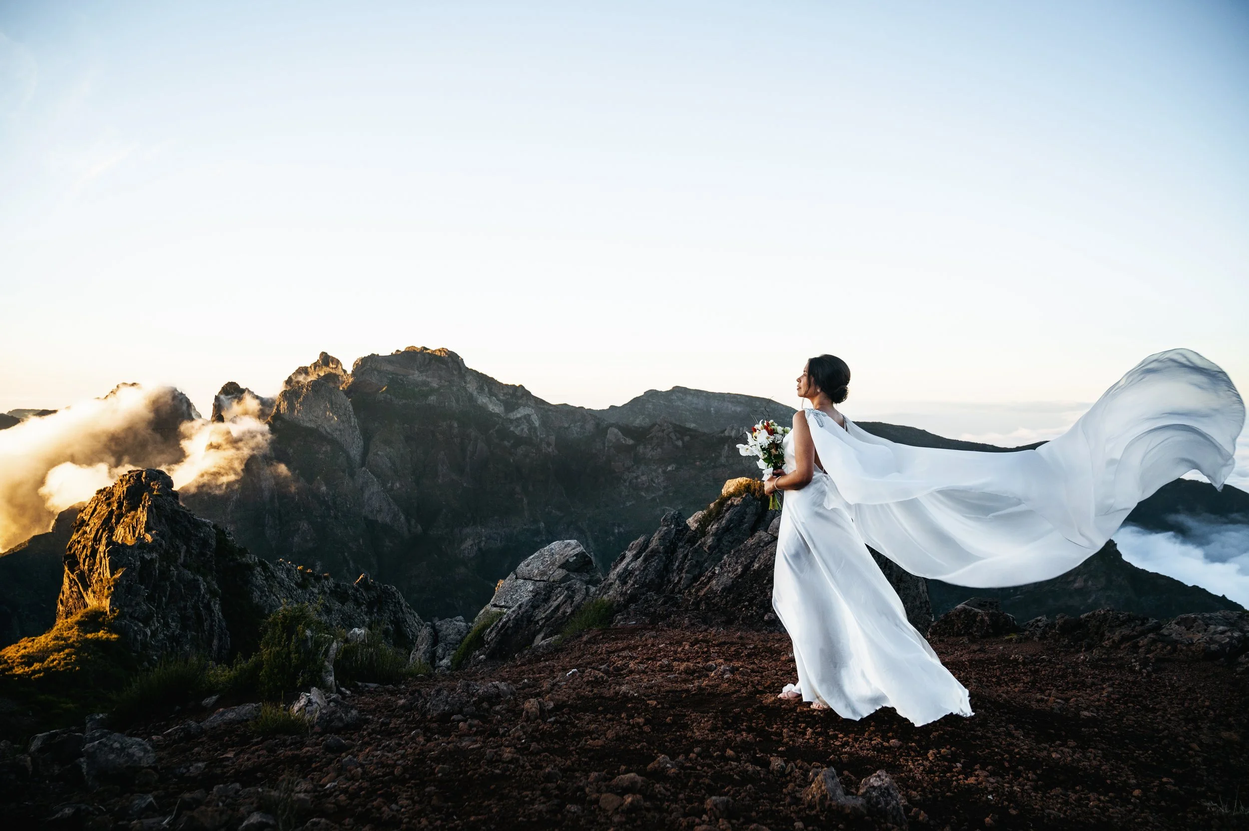 just married bride eloped on the mountains of madeira above the clouds with flying veil